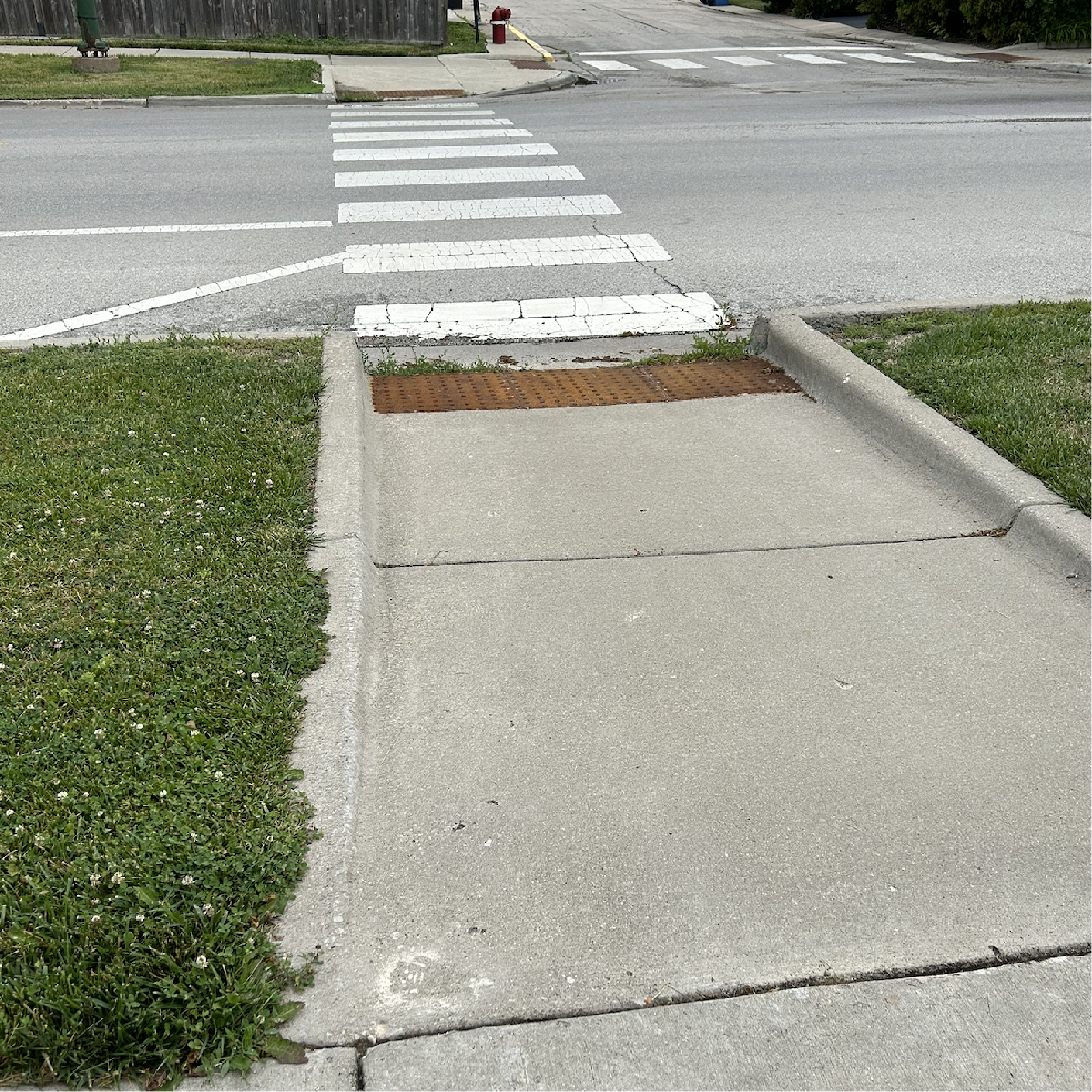 Yellow sidewalk bear on ramp in middle of a block